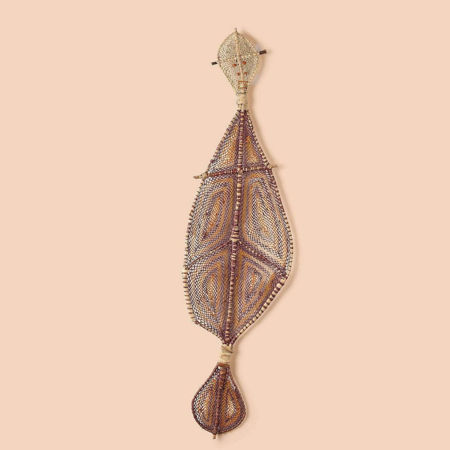 A handwoven artwork featuring pandanus fibers in a flowing form, in shades of brown and beige, representing the Yawkyawk.