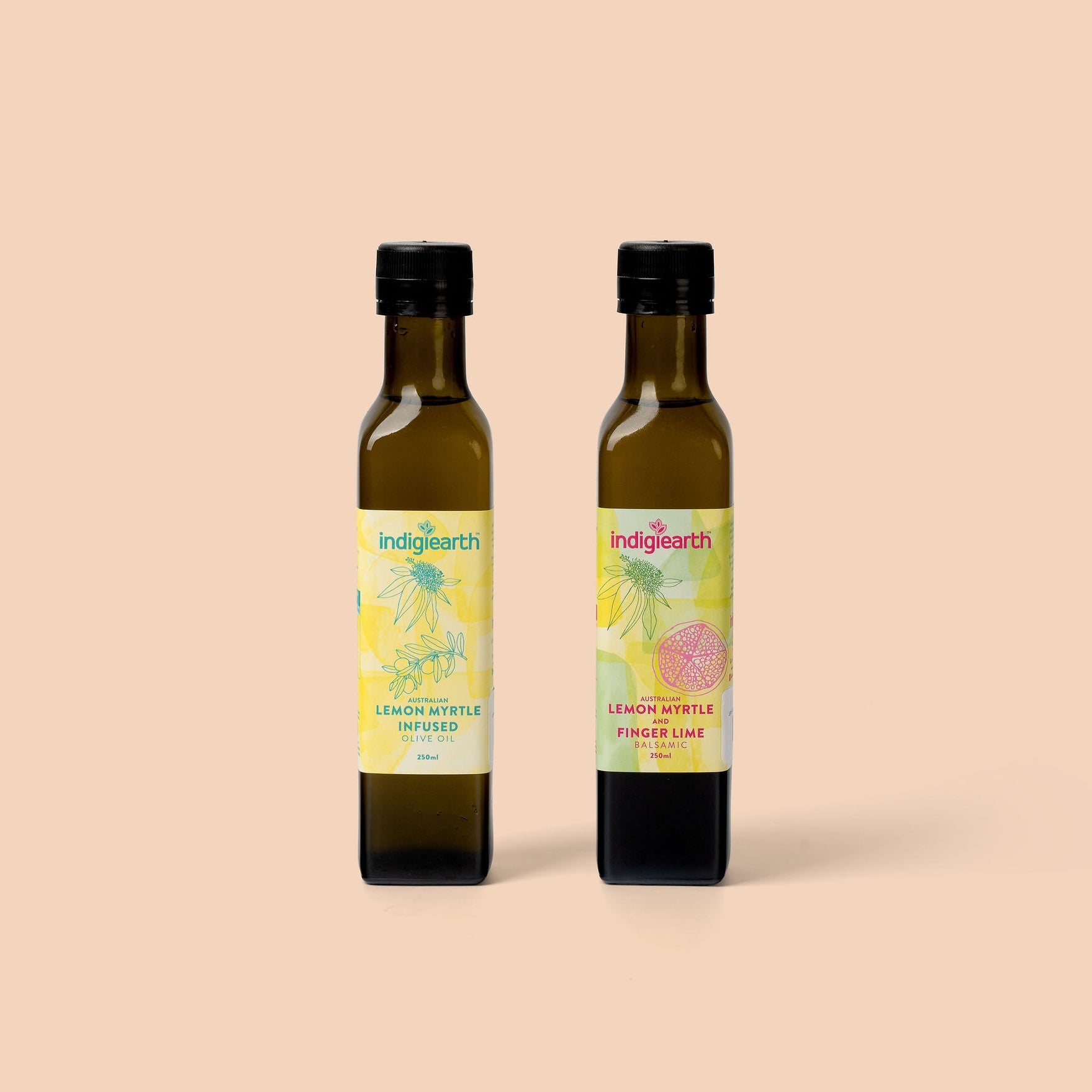 Two bottles of Indigearth lemon myrtle and finger lime flavored oils on a beige background