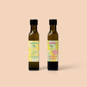 Two bottles of Indigearth lemon myrtle and finger lime flavored oils on a beige background
