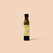 Bottle of Indigearth lemon myrtle finger lime oil on a beige background