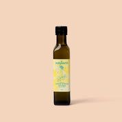 Bottle of lemon myrtle-infused oil on a beige background